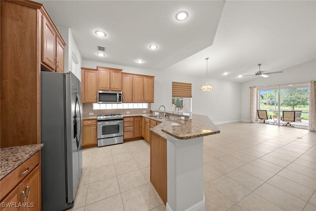 kitchen featuring visible vents, appliances with stainless steel finishes, open floor plan, a peninsula, and a sink