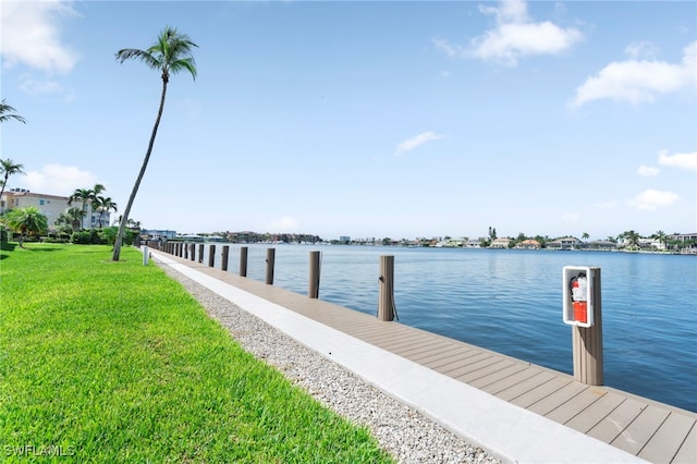 dock area with a water view and a lawn