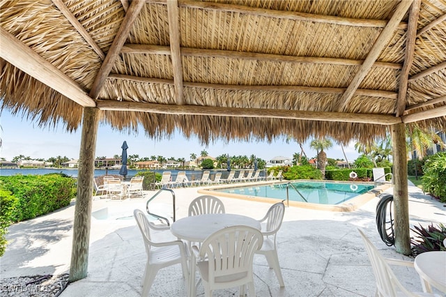 view of swimming pool with a gazebo, a patio area, and a water view