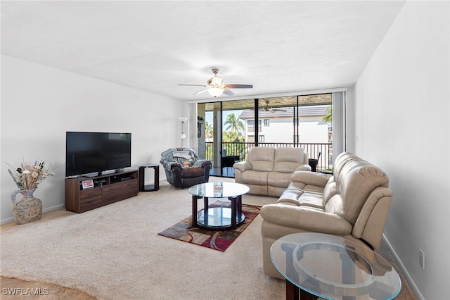 carpeted living room with ceiling fan and floor to ceiling windows