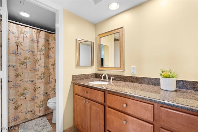 bathroom featuring vanity and toilet