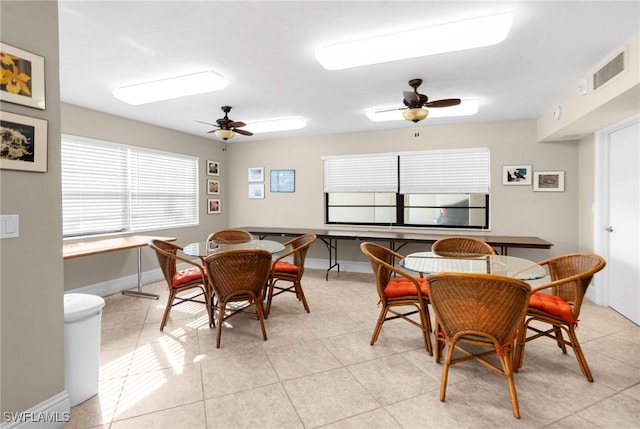 tiled dining space with ceiling fan