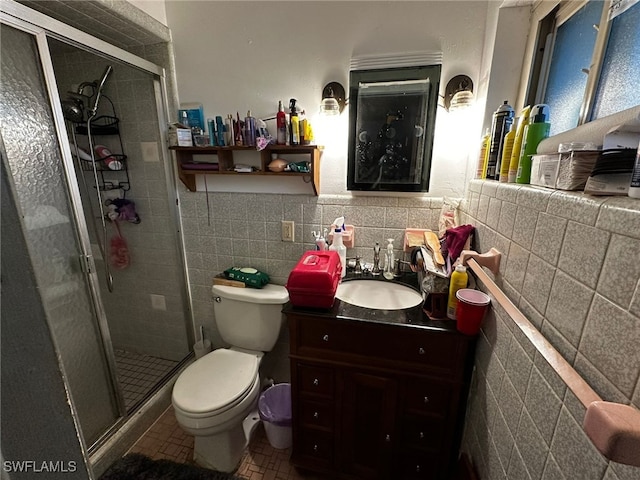 bathroom featuring vanity, toilet, tile walls, and walk in shower