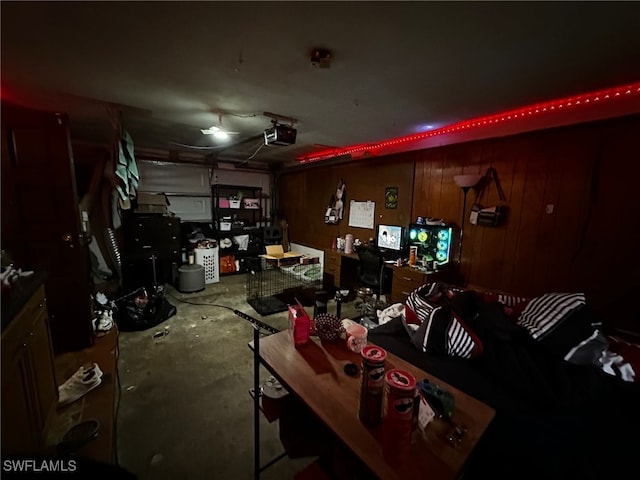 garage featuring a garage door opener and wooden walls