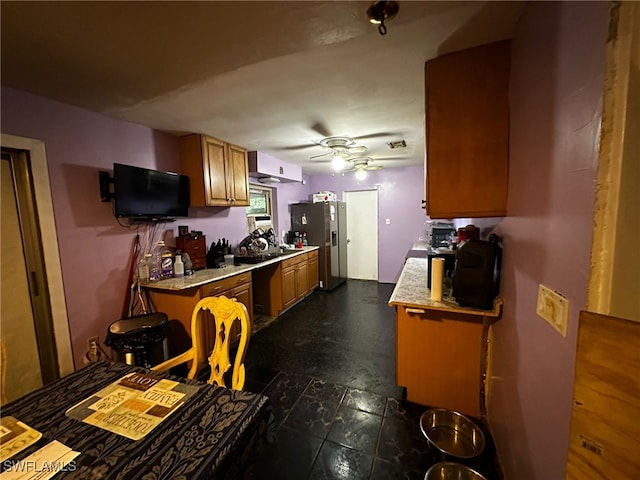 kitchen featuring stainless steel fridge with ice dispenser and ceiling fan