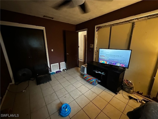 unfurnished living room with ceiling fan and light tile patterned floors