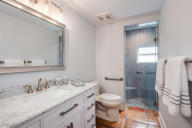 bathroom with vanity, tile patterned floors, toilet, and walk in shower