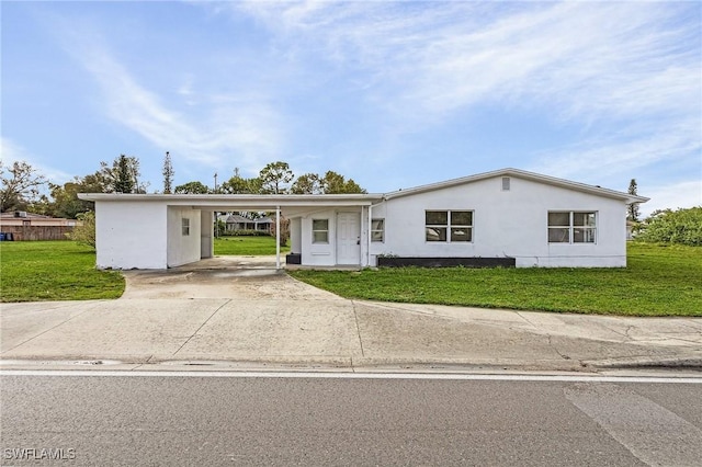 ranch-style house with a carport and a front lawn