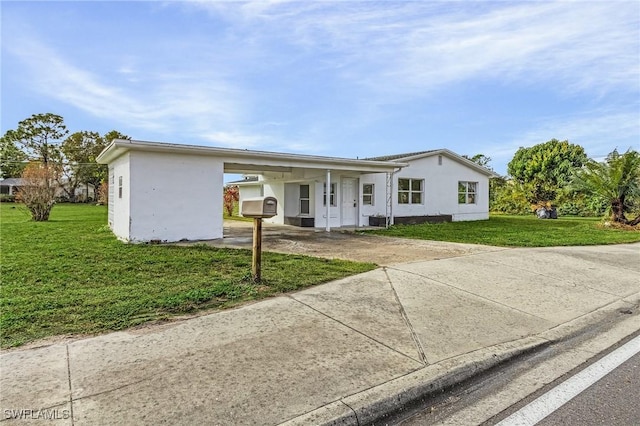 ranch-style house with a carport, a front yard, and cooling unit