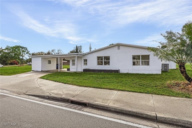 ranch-style house with a carport, cooling unit, and a front lawn