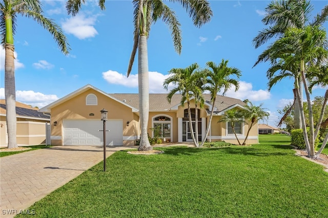 view of front of property featuring a garage and a front lawn