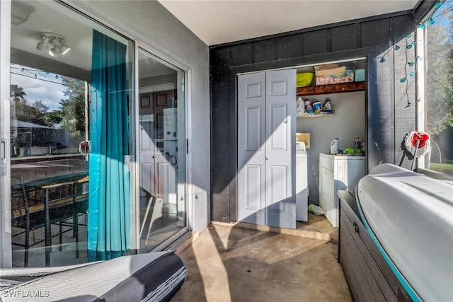 bathroom featuring washer and dryer and concrete floors