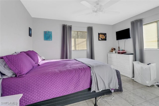 tiled bedroom featuring ceiling fan