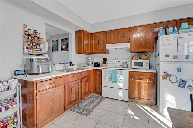 kitchen with sink, white appliances, and light tile patterned floors