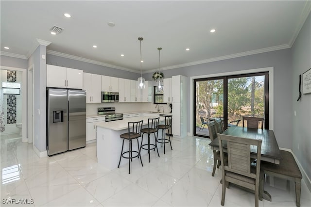 kitchen featuring white cabinetry, decorative light fixtures, a kitchen island, and appliances with stainless steel finishes