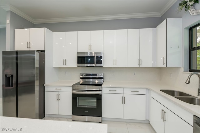 kitchen featuring sink, white cabinetry, tasteful backsplash, ornamental molding, and stainless steel appliances