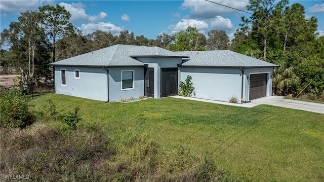 view of front of property with a garage and a front yard