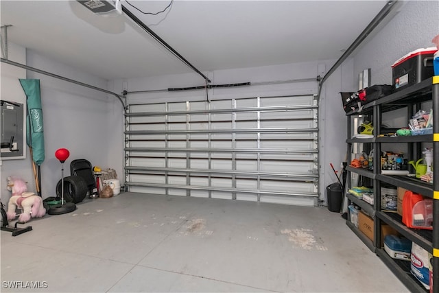 garage featuring a garage door opener and electric panel