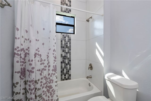 bathroom featuring shower / tub combo with curtain and toilet