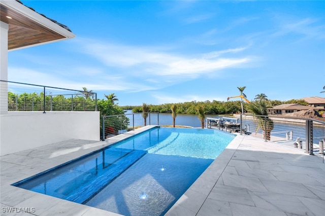 view of swimming pool featuring a water view and a patio