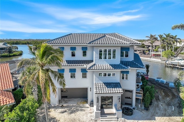 view of front facade with a garage and a water view