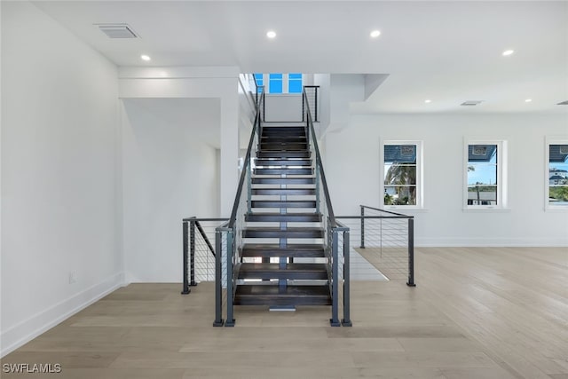 staircase with wood-type flooring