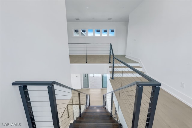 stairs featuring hardwood / wood-style floors