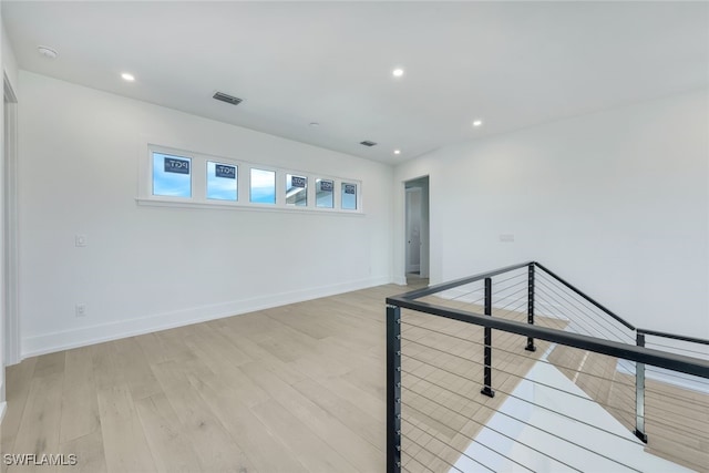 unfurnished room with light hardwood / wood-style flooring