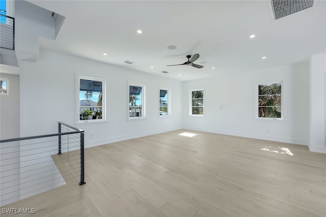 empty room with light hardwood / wood-style floors and ceiling fan