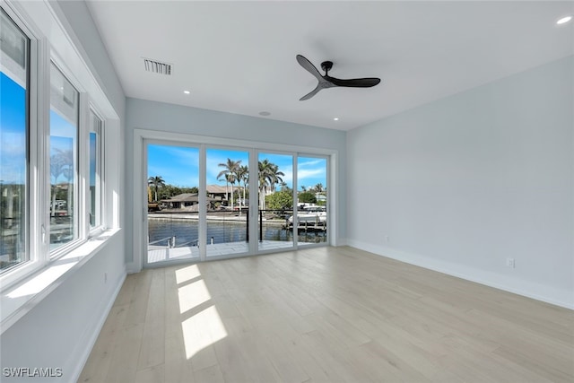 spare room with light hardwood / wood-style flooring and ceiling fan