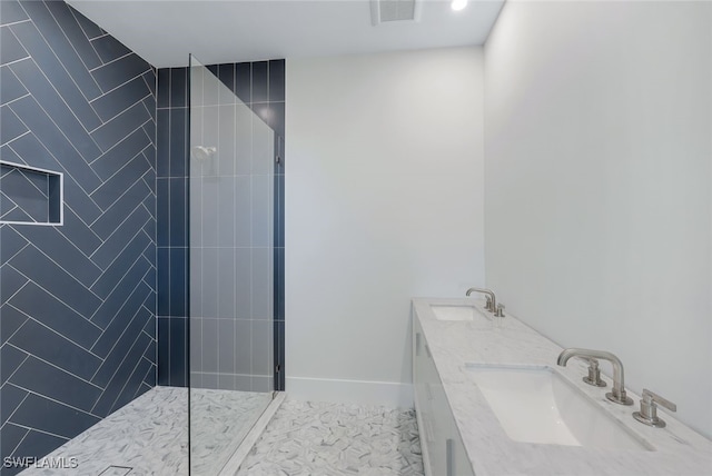 bathroom featuring vanity and tiled shower