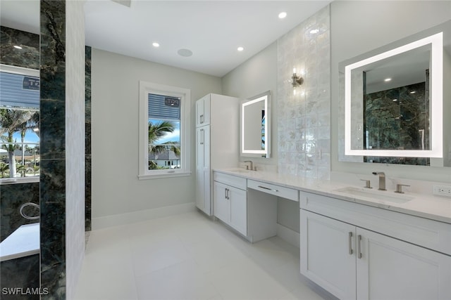 bathroom featuring vanity, a healthy amount of sunlight, and tile walls