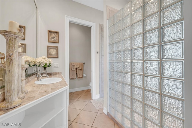 bathroom featuring tile patterned flooring, vanity, and toilet