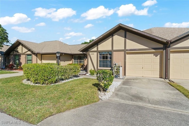 view of front of house with a garage and a front lawn