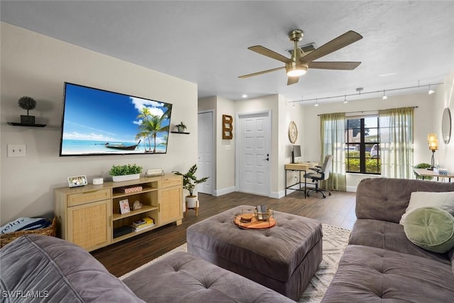 living room with dark hardwood / wood-style flooring, rail lighting, and ceiling fan