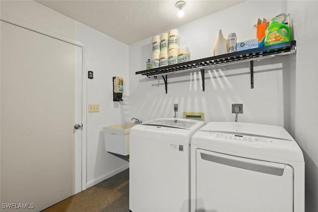 clothes washing area featuring washing machine and dryer and sink