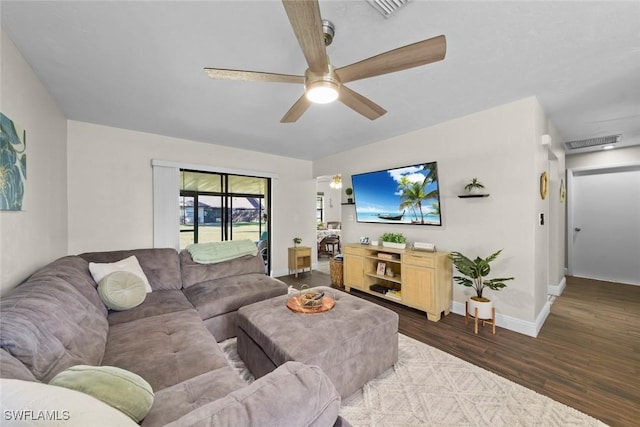 living room with ceiling fan and dark hardwood / wood-style floors