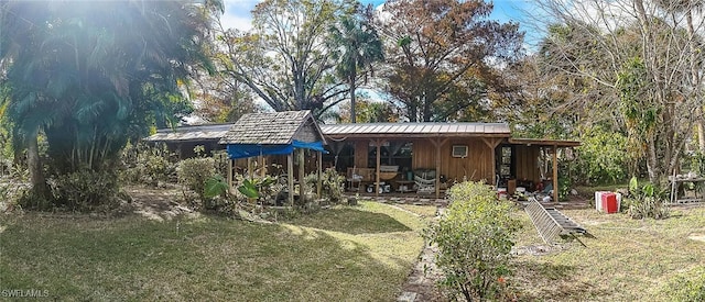 back of house with a lawn