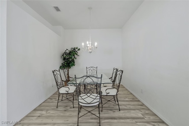 dining space featuring a notable chandelier and light hardwood / wood-style flooring