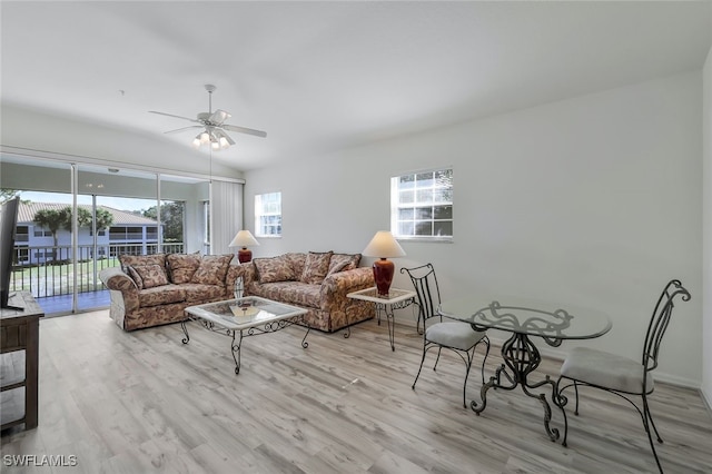 living room with ceiling fan and light wood-type flooring