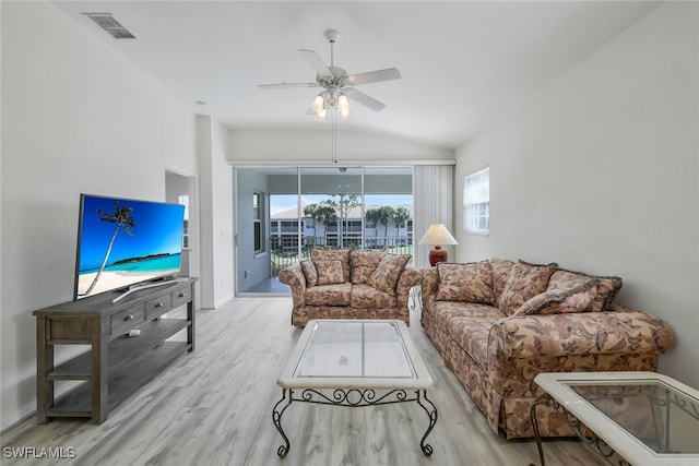 living room with lofted ceiling, ceiling fan, and light hardwood / wood-style flooring