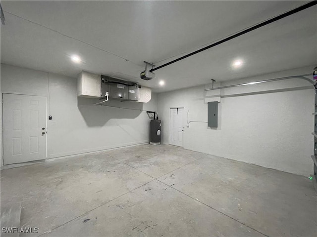 garage with a garage door opener, electric panel, and electric water heater