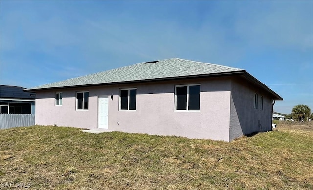 rear view of property with a yard