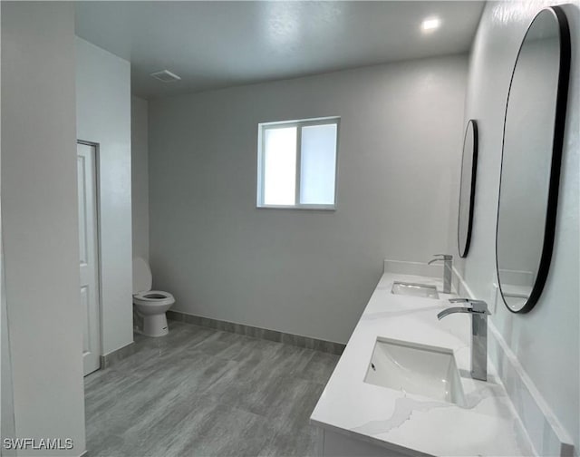 bathroom with vanity, hardwood / wood-style floors, and toilet