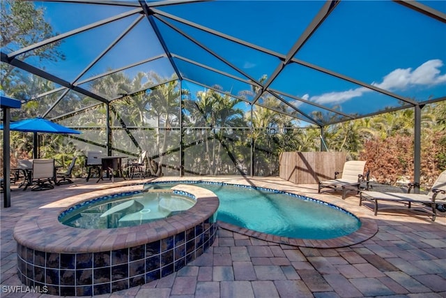 view of swimming pool with an in ground hot tub, a lanai, and a patio