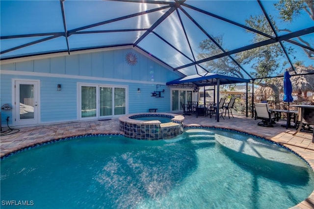 view of pool featuring an in ground hot tub, a lanai, and a patio