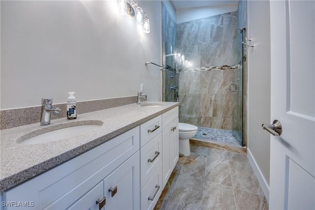 bathroom featuring an enclosed shower, vanity, and toilet