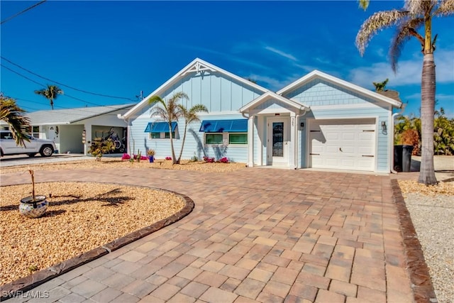 365 Donora Blvd, Fort Myers Beach, FL 33931 - single story home featuring board and batten siding, curved driveway, and an attached garage