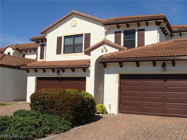 mediterranean / spanish-style home with a garage