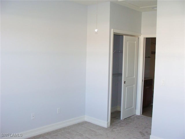 interior space with a closet and light carpet